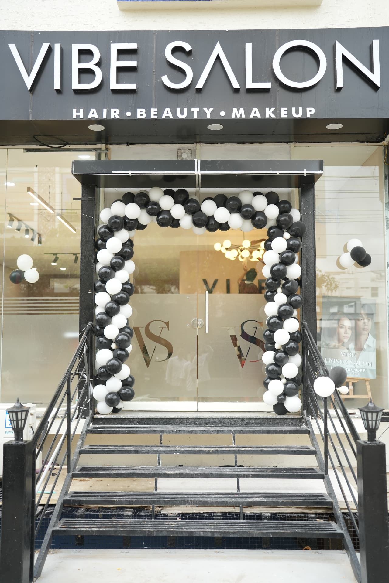 Vibe Salon storefront entrance with balloon arch